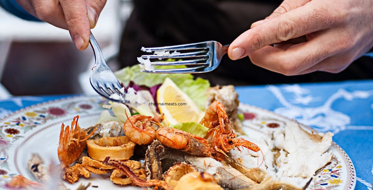 Eating Seafood Dinner in Restaurant